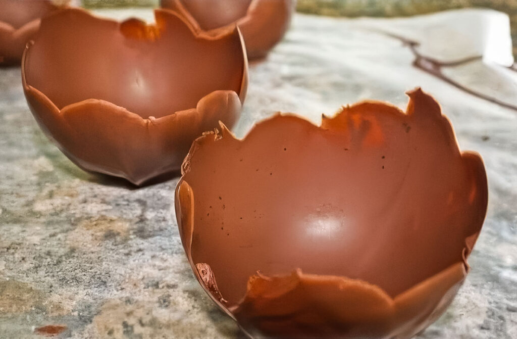 Easy Chocolate Bowls with Balloons – A Fun No-Bake Dessert! Multiple chocolate bowls drying on parchment paper, ready to be filled