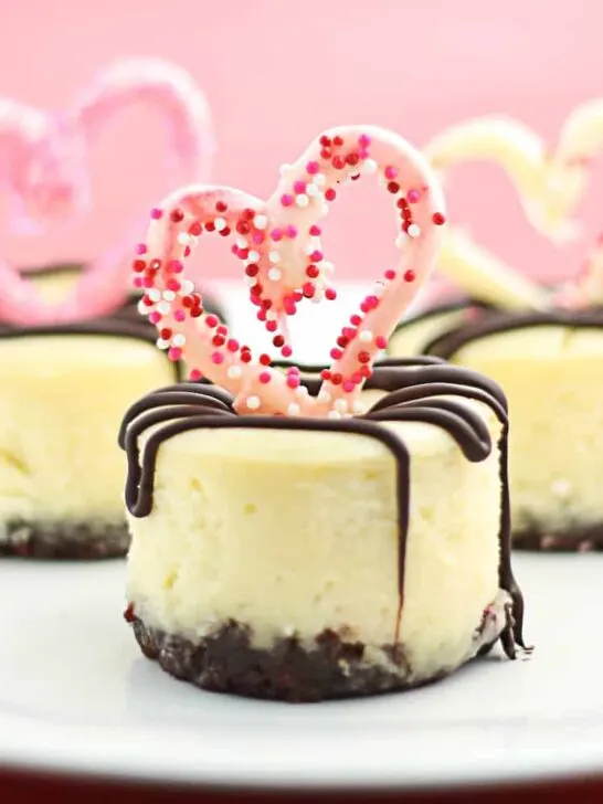 Mini Cheesecakes with a Nutella crust, topped with chocolate hearts & a chocolate-stuffed raspberry center. They really are the Best Mini Cheesecakes Ever!