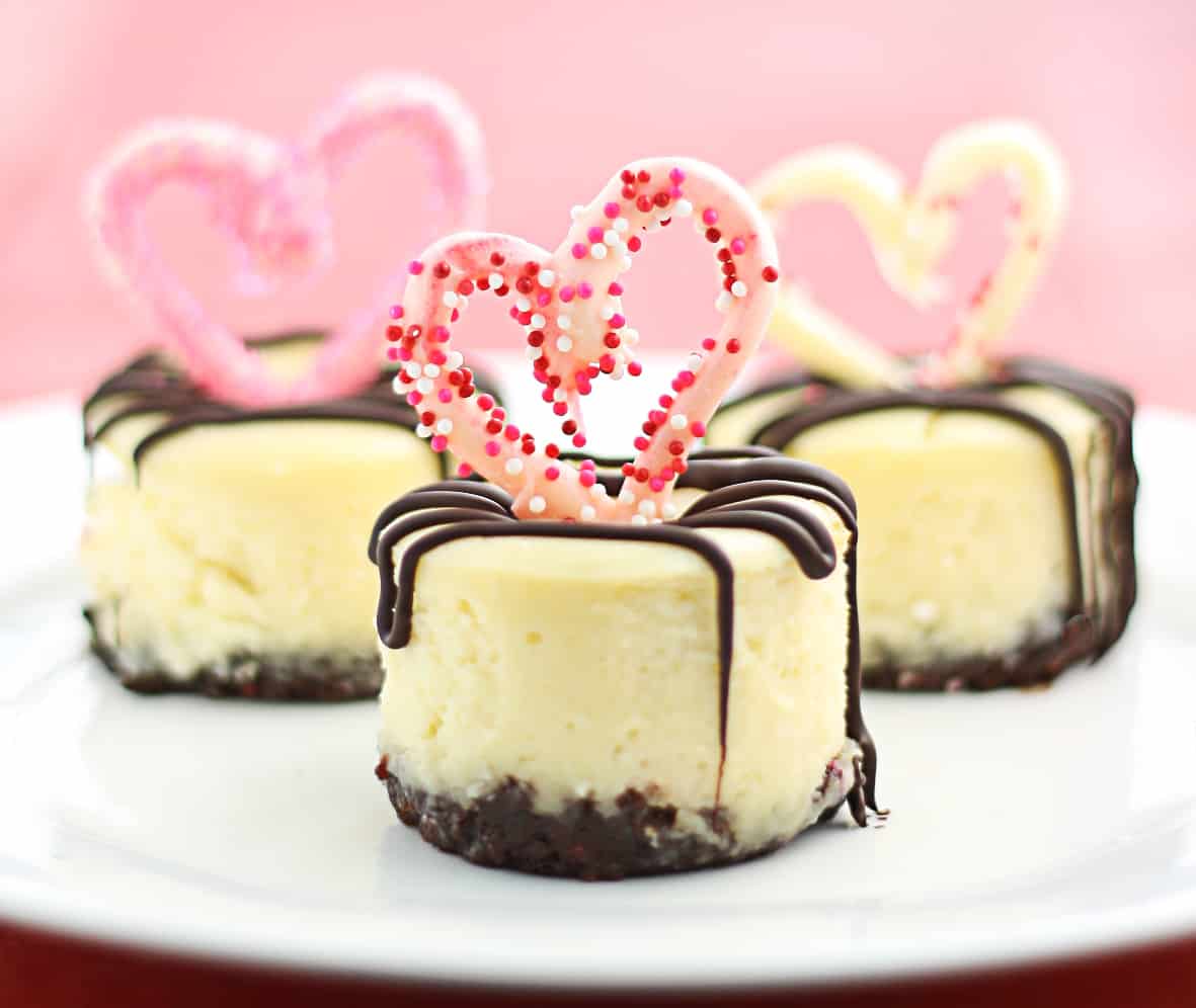 Mini Cheesecakes with a Nutella crust, topped with chocolate hearts & a chocolate-stuffed raspberry center. They really are the Best Mini Cheesecakes Ever!