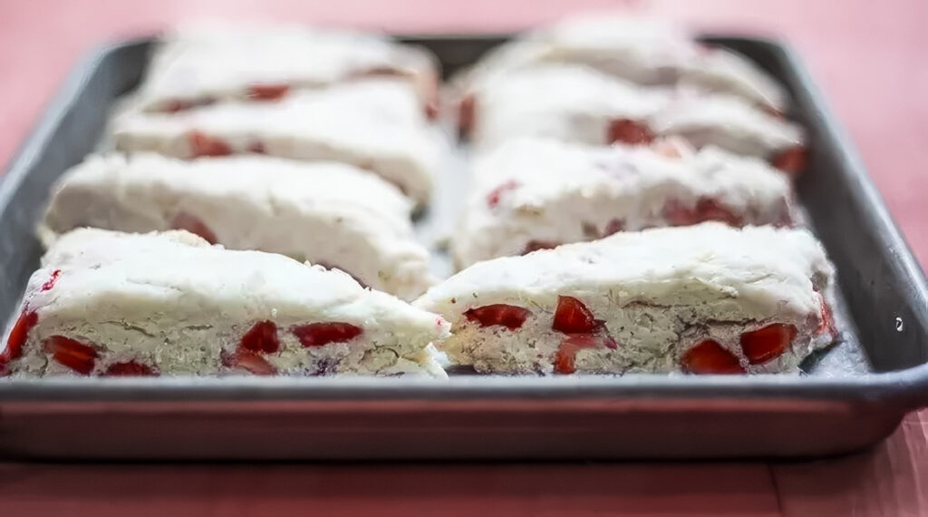 Strawberry Lemon Scones step 4: a batch of strawberry lemon scones on a sheet pan, ready for the oven