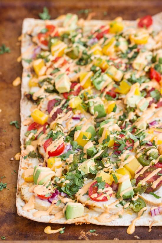 This flavorful chicken flatbread recipe has a smoky sauce, cilantro-lime chicken, mango & roasted jalapeno which makes for one killer flatbread pizza!