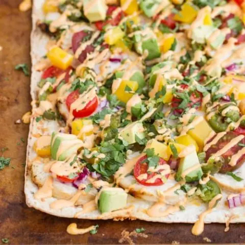 This flavorful chicken flatbread recipe has a smoky sauce, cilantro-lime chicken, mango & roasted jalapeno which makes for one killer flatbread pizza!
