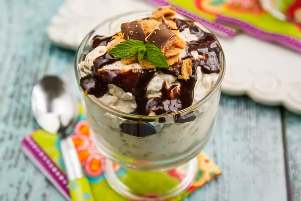 The Best No Bake Butterfinger Pie – Just 10 Minutes Prep! a dish of no bake butterfinger pie on a colorful napkin with a spoon