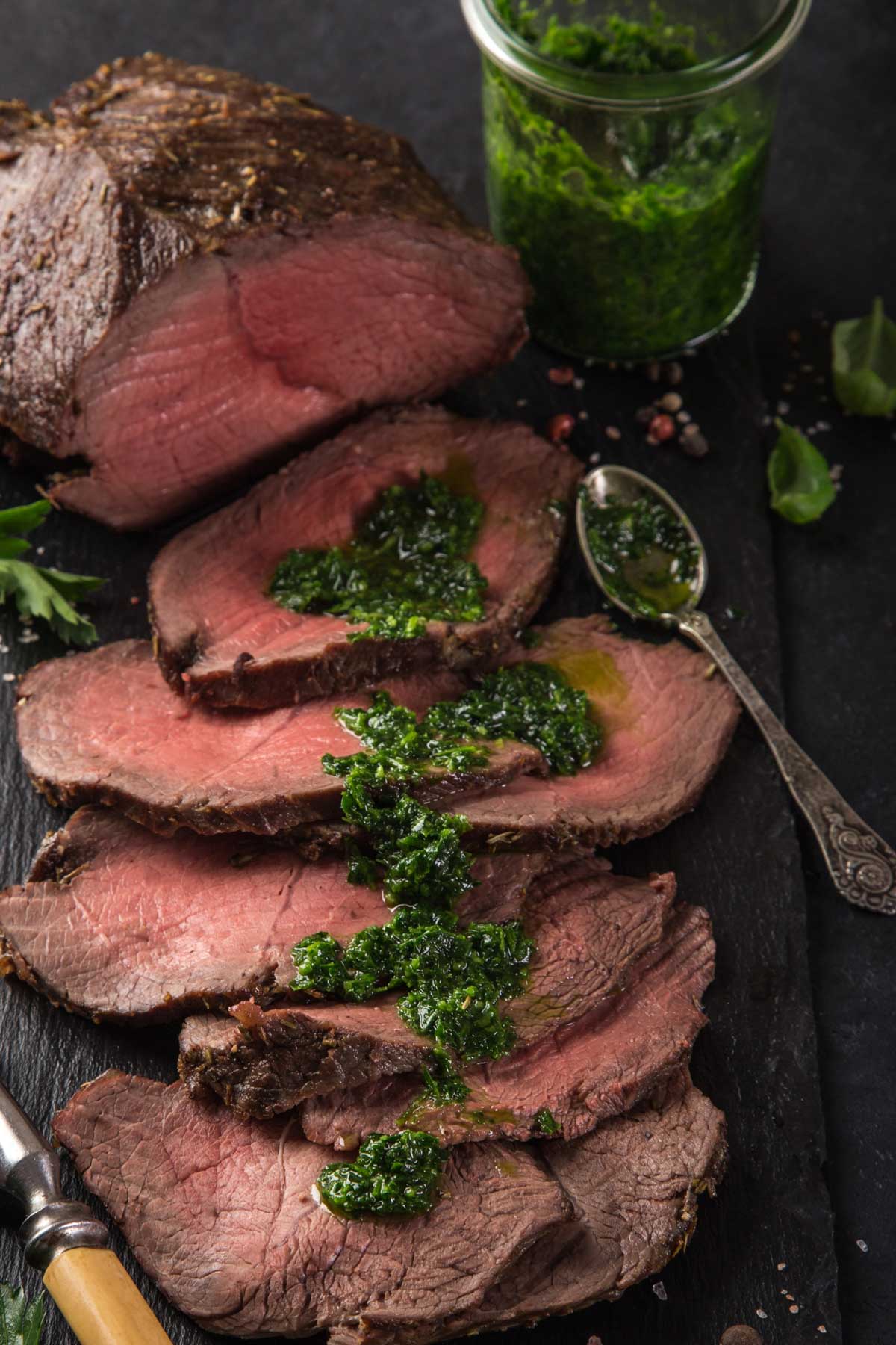 slices of freshly roasted beef topped with chimichurri as a way to show how to use chimichurri