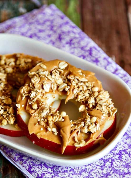 This healthy snack is so much better than you would think! Slice an apple, spread on creamy peanut butter and sprinkle with granola. So easy and good.
