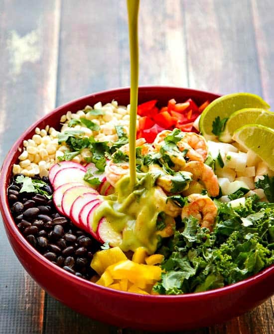 This Chopped Salad Recipe is filled with all good things and packed with flavor! Topped with Cumin Lime Shrimp and tossed with a Cilantro Lime Dressing that is light and flavorful but can be made spicy with a little jalapeno. A delicious way to eat healthy!
