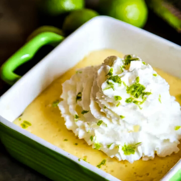 an individual key lime pie made with a granola crust, topped with whipped cream and fresh lime zest