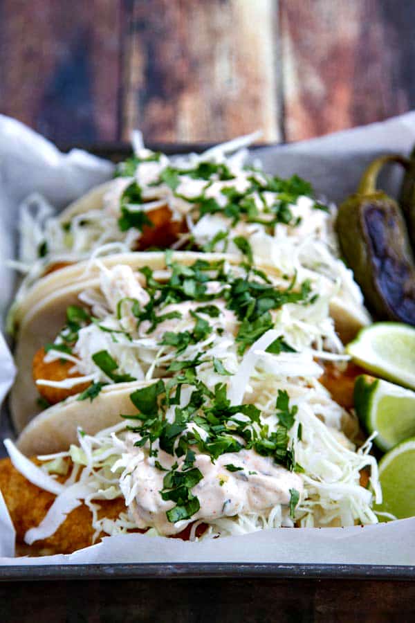 These Beer Battered Fish Tacos light and crispy with a killer sauce that brings all the flavors together!