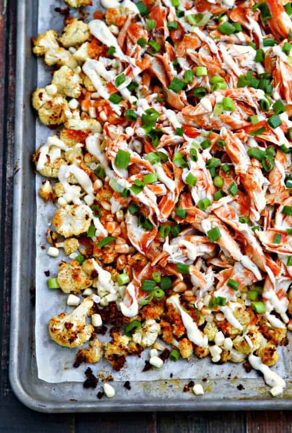 Buffalo Ranch Roasted Cauliflower "Nachos" - Roasted cauliflower with ranch dressing, fresh corn, shredded chicken and a hearty drizzle of buffalo sauce and a little more ranch. Get your veggies the delicious way! You can also make the Ranch Roasted Cauliflower on its own - so good!