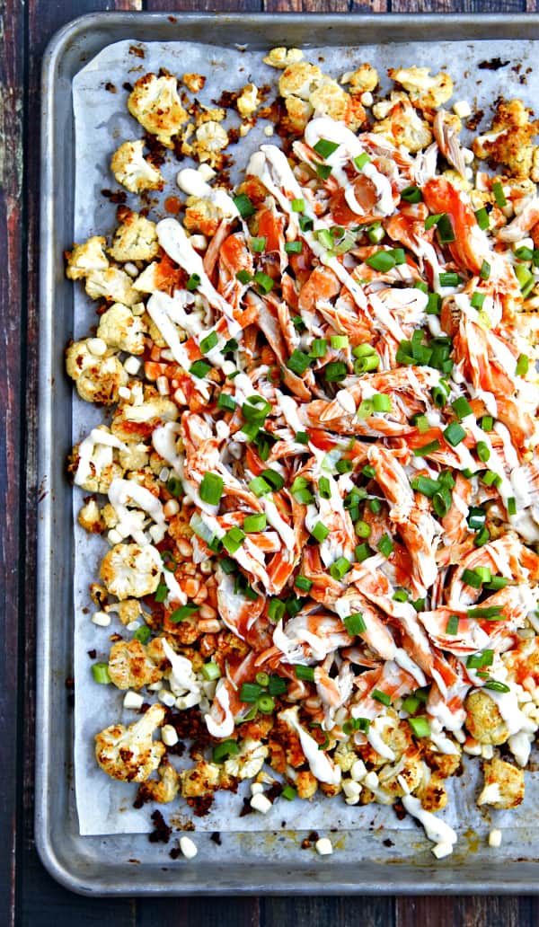 Buffalo Ranch Roasted Cauliflower "Nachos" - Roasted cauliflower with ranch dressing, fresh corn, shredded chicken and a hearty drizzle of buffalo sauce and a little more ranch. Get your veggies the delicious way! You can also make the Ranch Roasted Cauliflower on its own - so good!