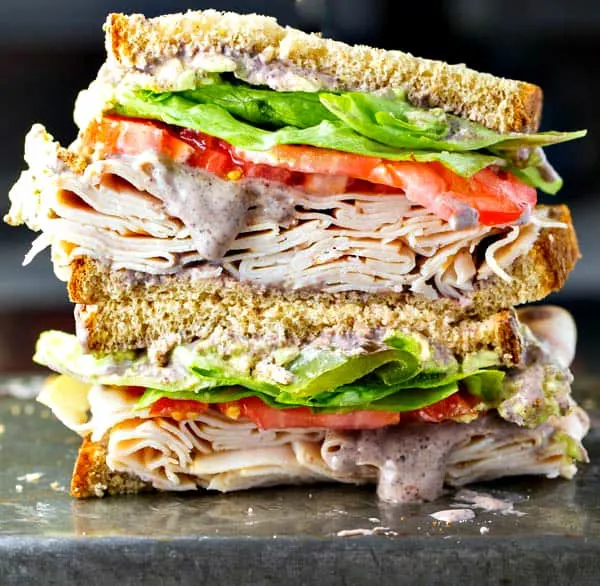 A healthy turkey sandwich recipe! Piled high with turkey, lettuce, tomato, roasted anaheim peppers and a creamy black bean spread! 
