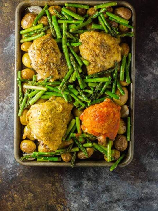 One-pan oven baked chicken thighs with potatoes and your side, plus a technique that easily allows for a different flavor chicken for each member of the family (and it only takes a minute)!