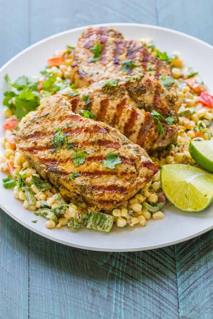 Grilled Boneless Pork Chops with Mexican Corn Salad. Healthy and SO flavorful! The easiest, most flavorful salad (I swear I could drink the dressing)!
