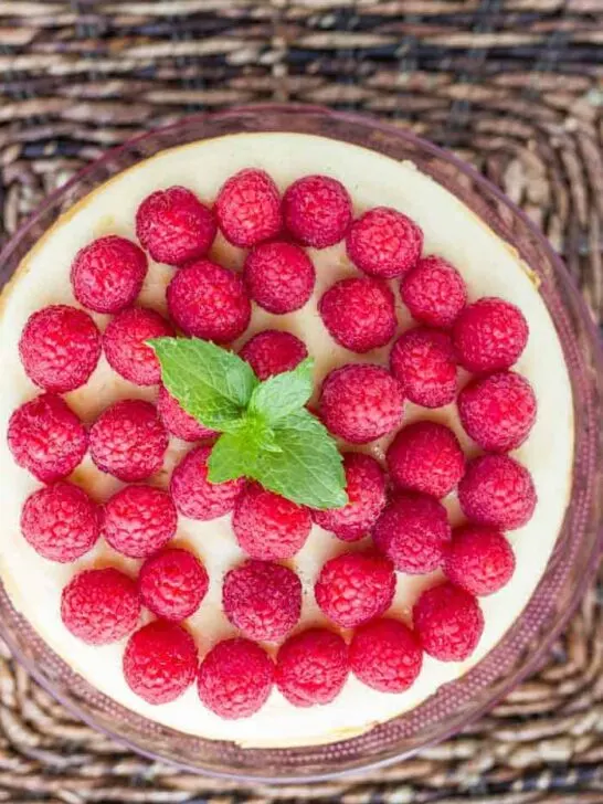 Lemon Instant Pot Cheesecake - the creamiest cheesecake we've made in our Instant Pot (or otherwise) yet! The gingerbread crust pairs perfectly with the delicate lemon flavor. Top it with fresh raspberries for a show-stopping dessert!