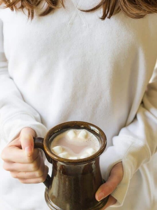 Girl holding mug of hot chocolate with marshmallows (TruMoo Chocolate Milk)