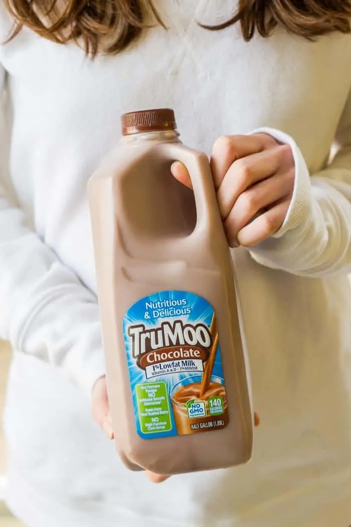 Girl holding carton of TruMoo chocolate milk