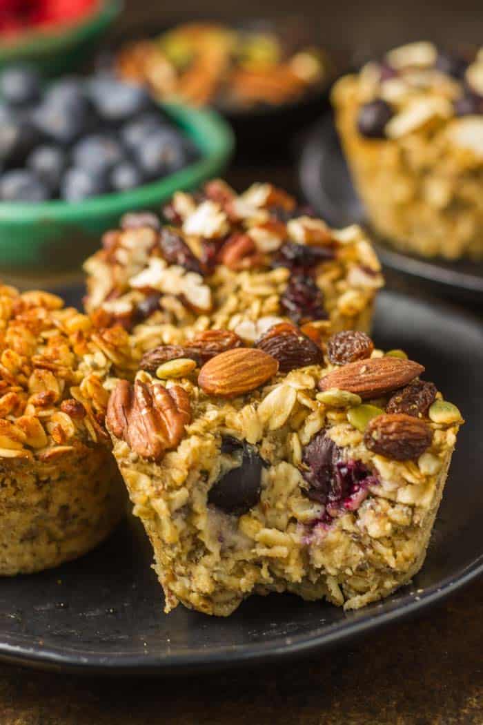 Baked Oatmeal Cups in muffin tin just out of the oven on a black plate.
