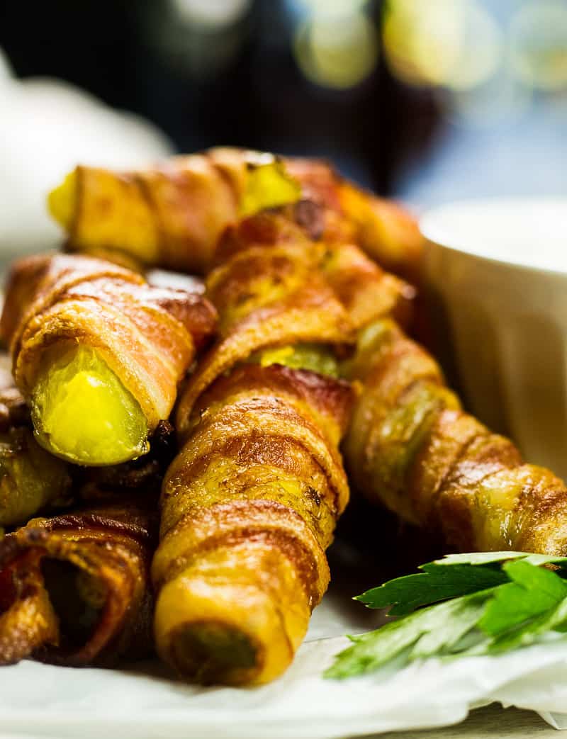 Bacon Wrapped Pickles (Pickle Fries) in a pile on a plate.