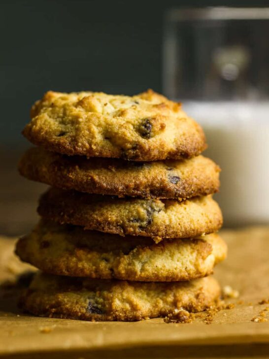 A stack of keto chocolate chip cookies next to a glass of milk