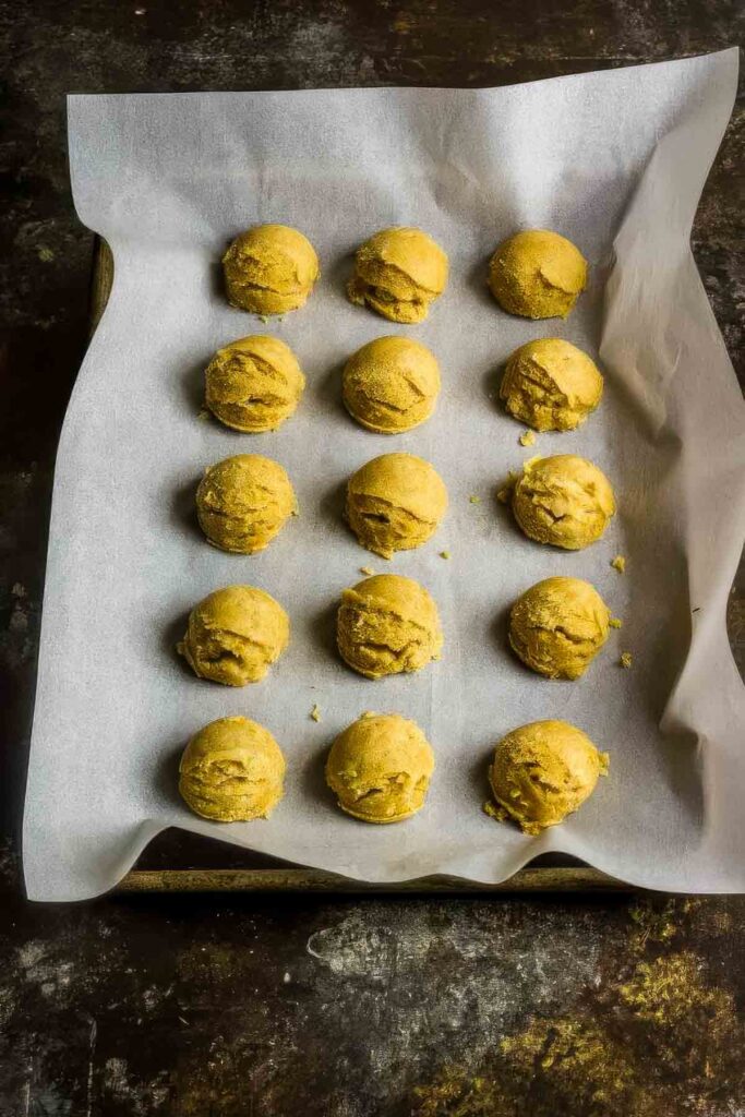 keto cookie dough bites on parchment paper ready to go into the fridge to chill