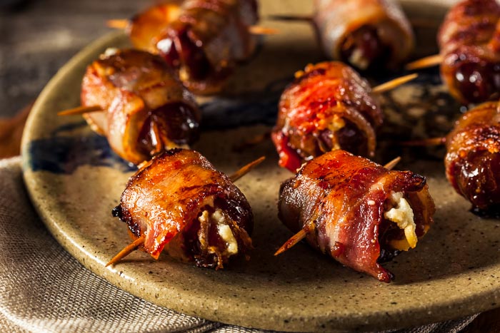 Bacon-wrapped dates with blue cheese on a plate