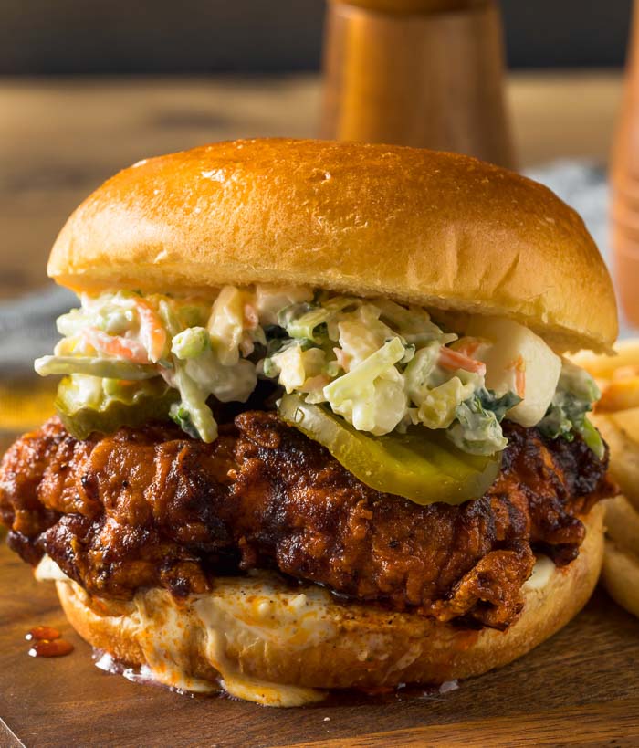 Nashville Hot Chicken on a bun with pickles and coleslaw