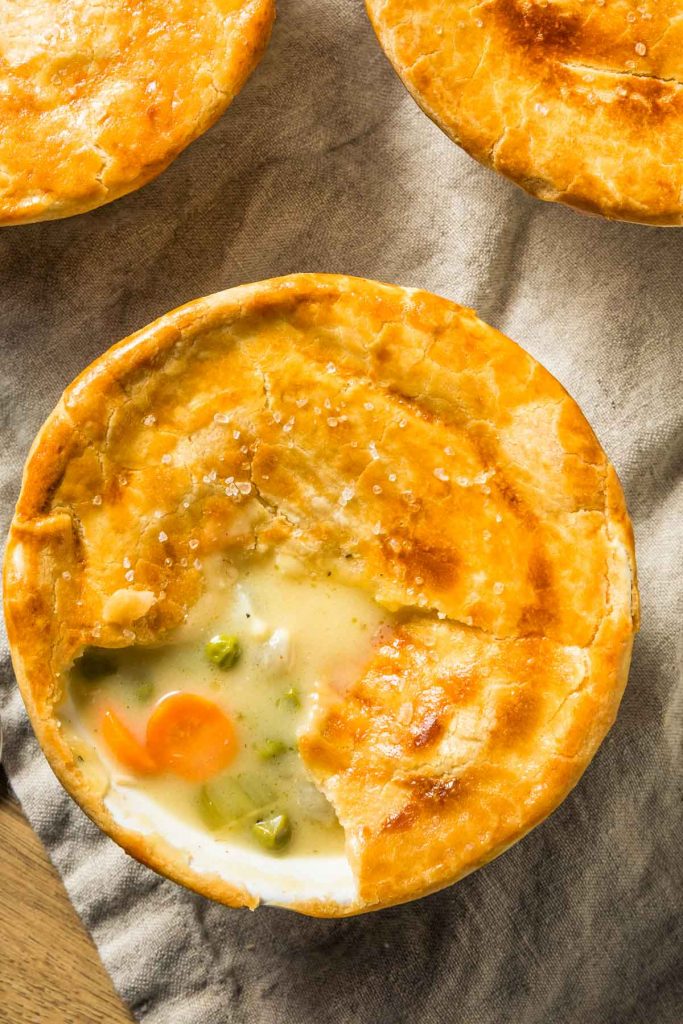 a closeup of individual instant pot chicken pot pies on a beige napkin
