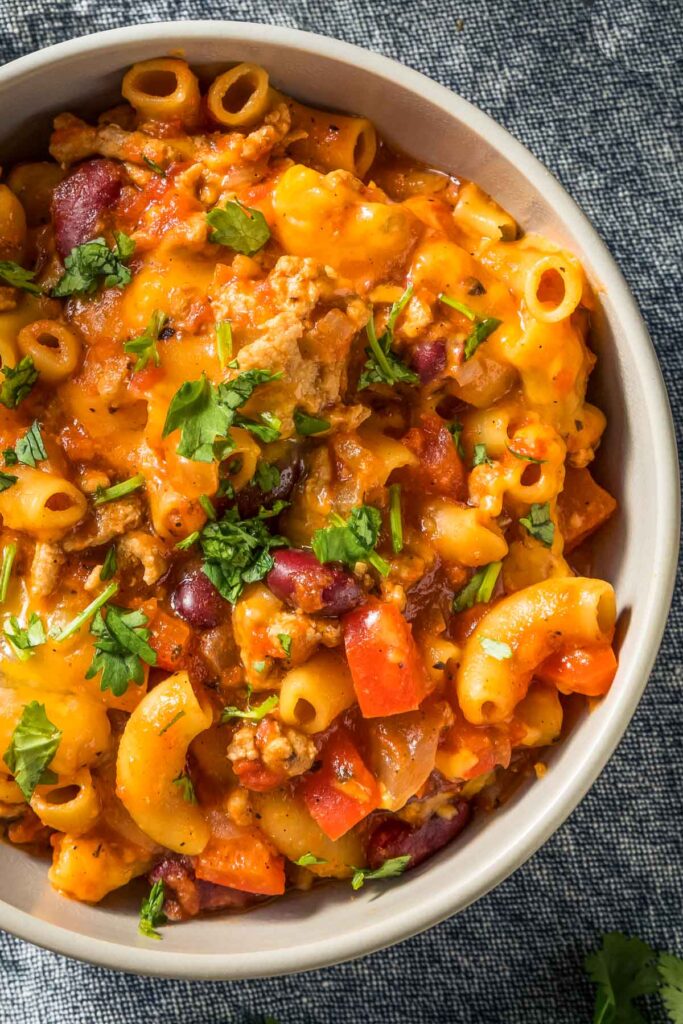 a closeup of a bowl of chili mac and cheese
