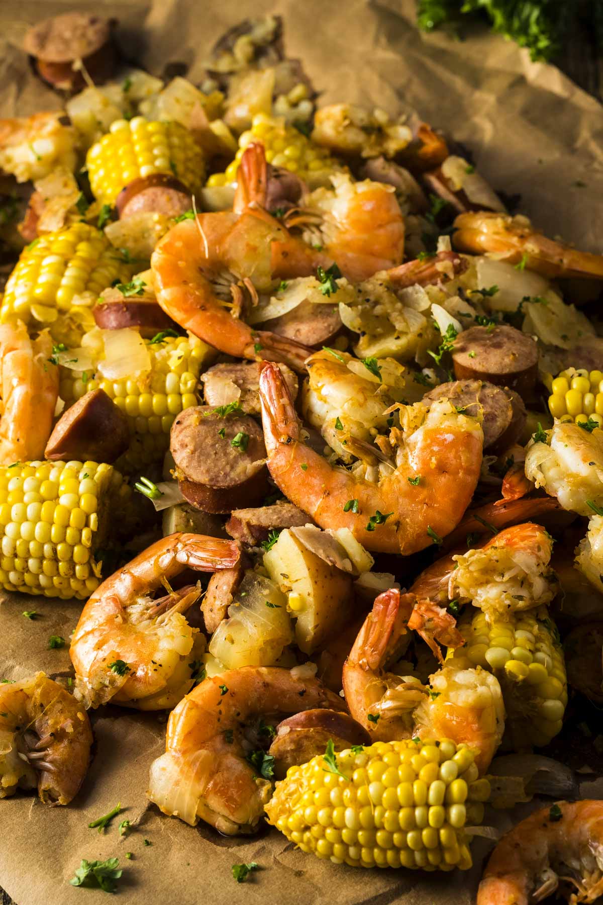Shrimp and Sausage Boil (One-Pot, 30 minutes) a fully cooked shrimp and sausage boil with corn and potatoes on a large sheet of parchment paper