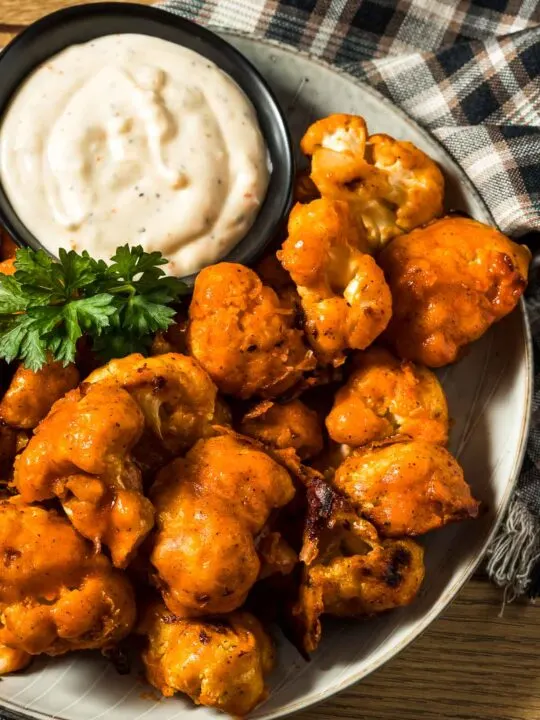 Closeup of Plate Of Buffalo Cauliflower Wings with Ranch Dressing on the Side