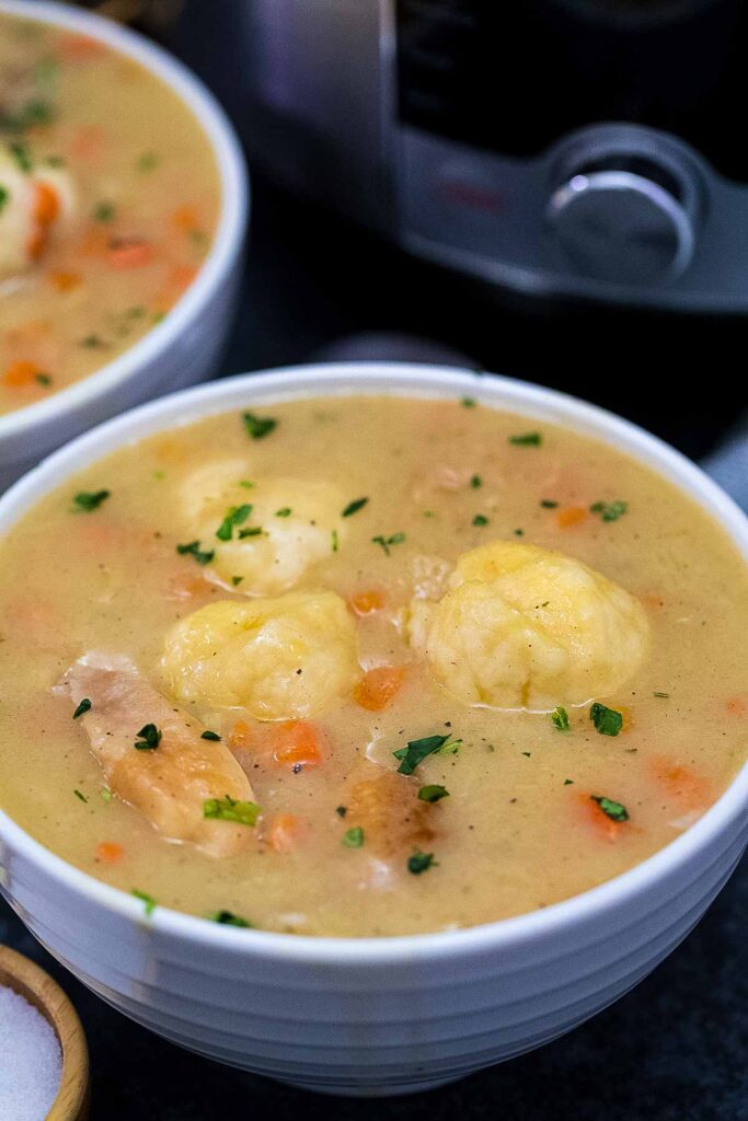 a bowl full of instant pot chicken and dumplings