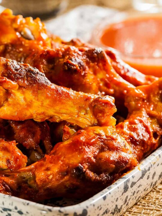 a plate of wings tossed with keto buffalo sauce