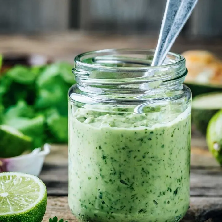 Jar of Avocado Lime Ranch Dressing with a Spoon