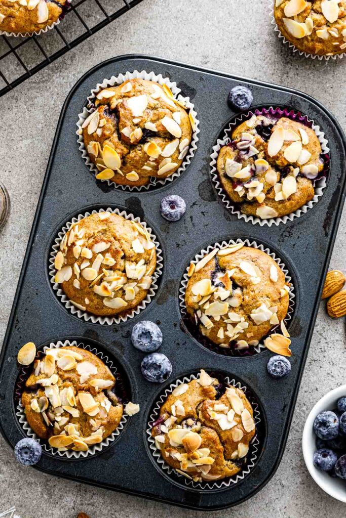 banana blueberry muffins in a muffin pan just out of the oven