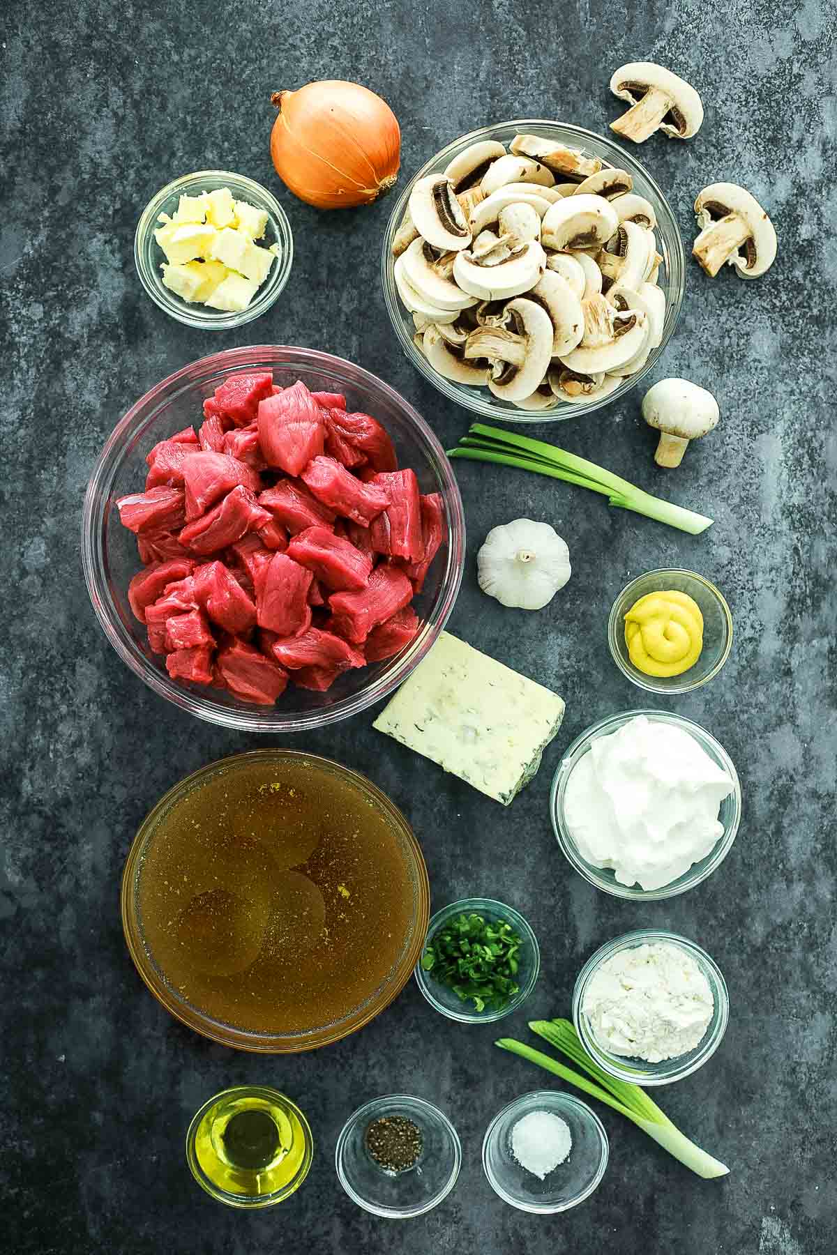 every ingredient used to make Instant Pot Beef Stroganoff, in separate dishes to show mise en place