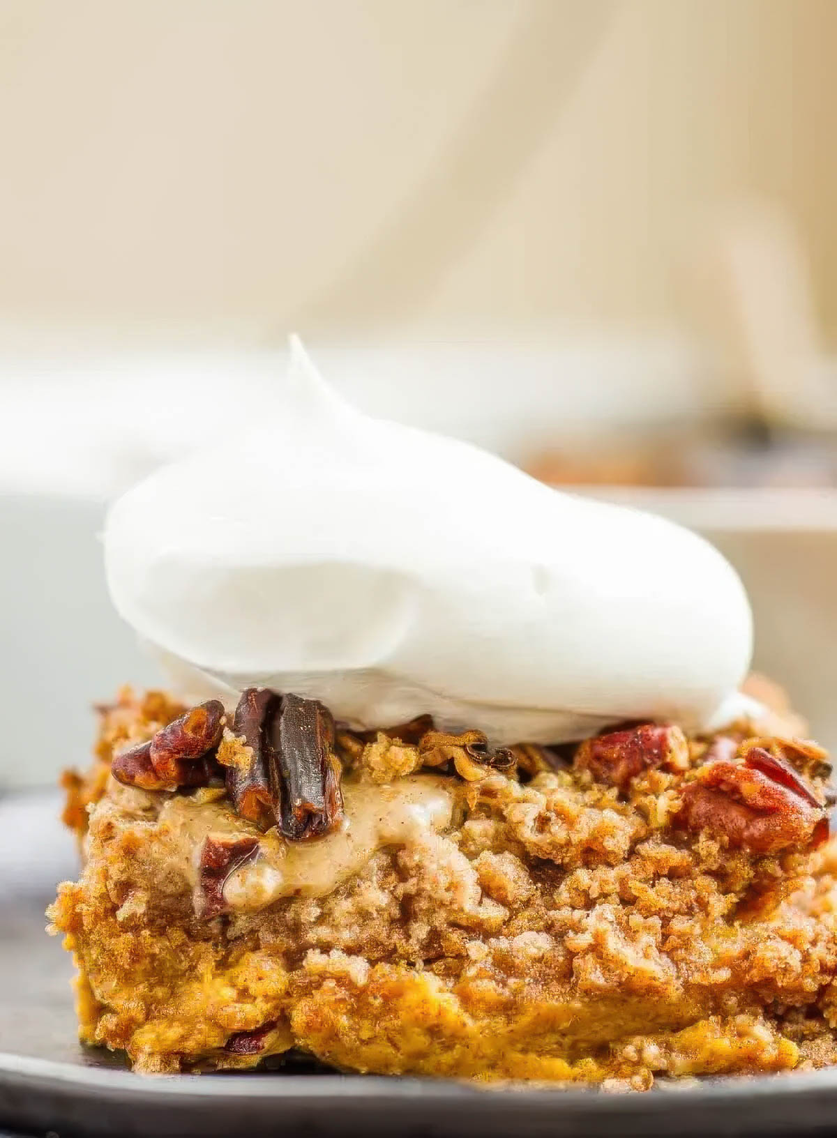 Easy Pumpkin Pie Cake Recipe (Better Than Pie!) a slice of pumpkin pie cake on a black plate topped with fresh whipped cream