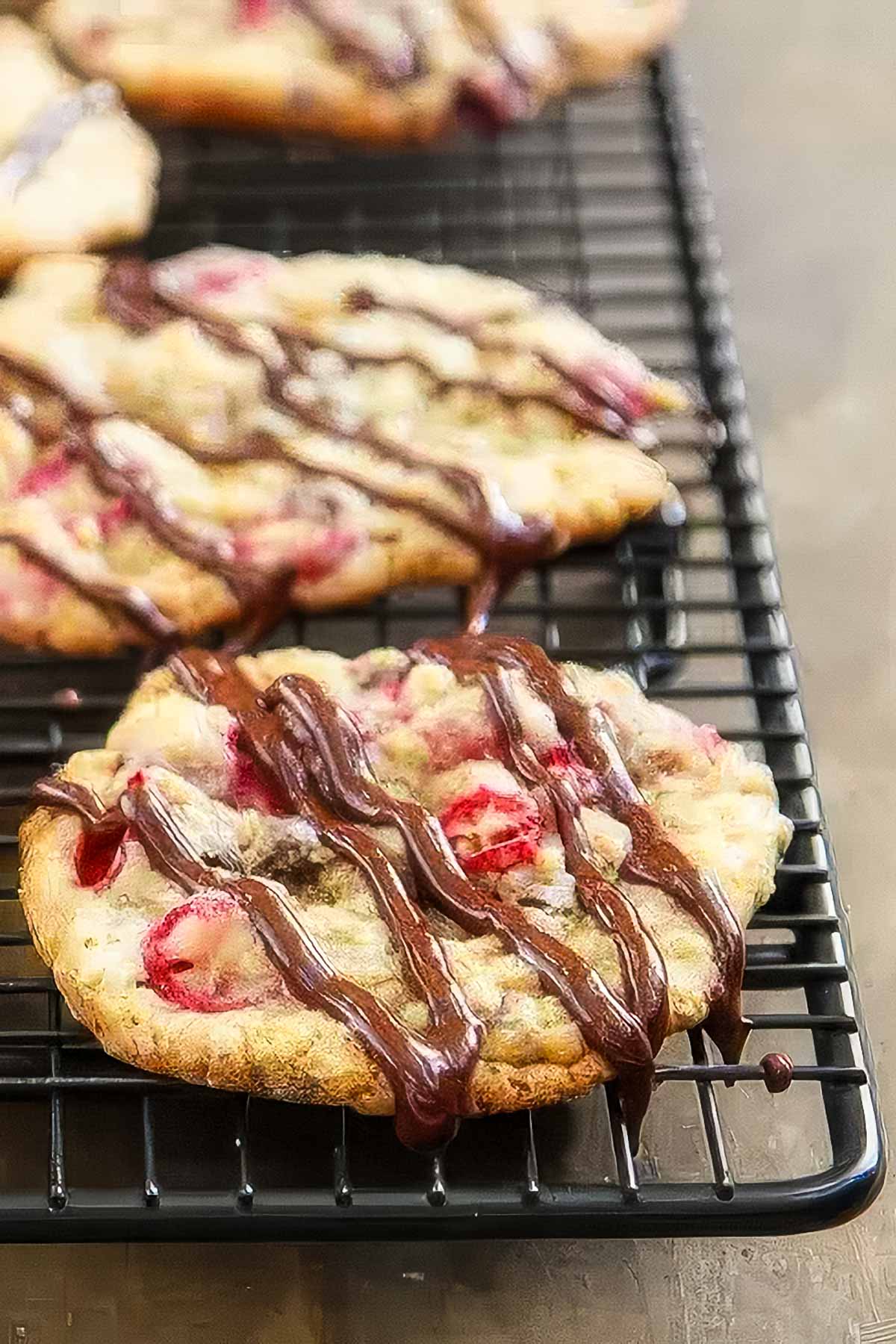 cranberry oatmeal chocolate chip cookies cooling on a wire rack