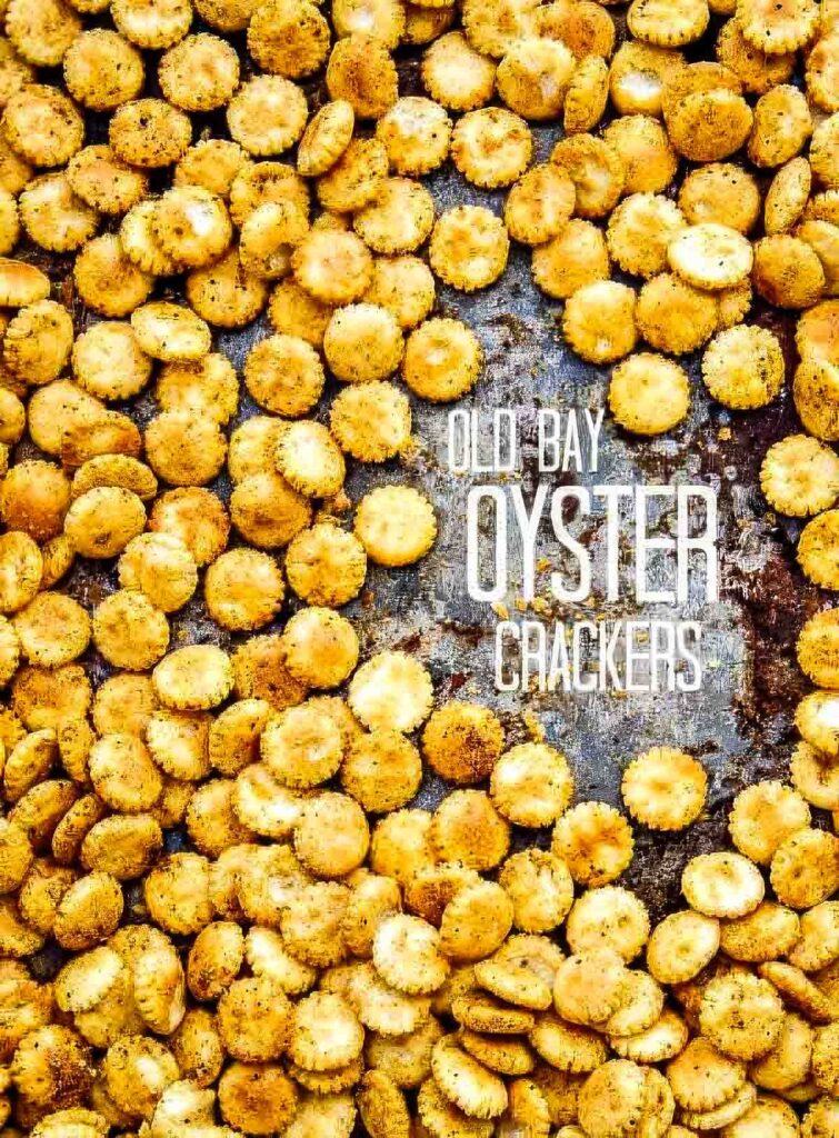 Old Bay Oyster Crackers (Easy Snack or Soup Topper!) Old Bay seasoned oyster crackers scattered across a rustic baking sheet, with visible spice coating and bold text overlay reading