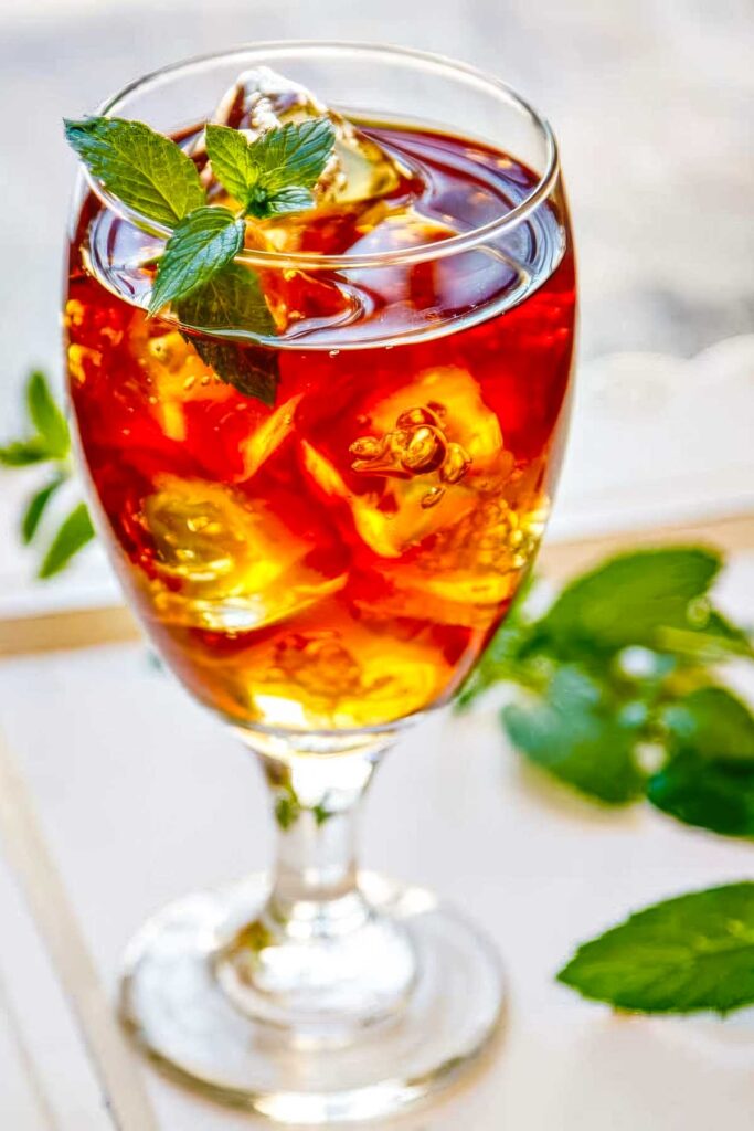 a sweet tea vodka cocktail with a sprig of fresh mint