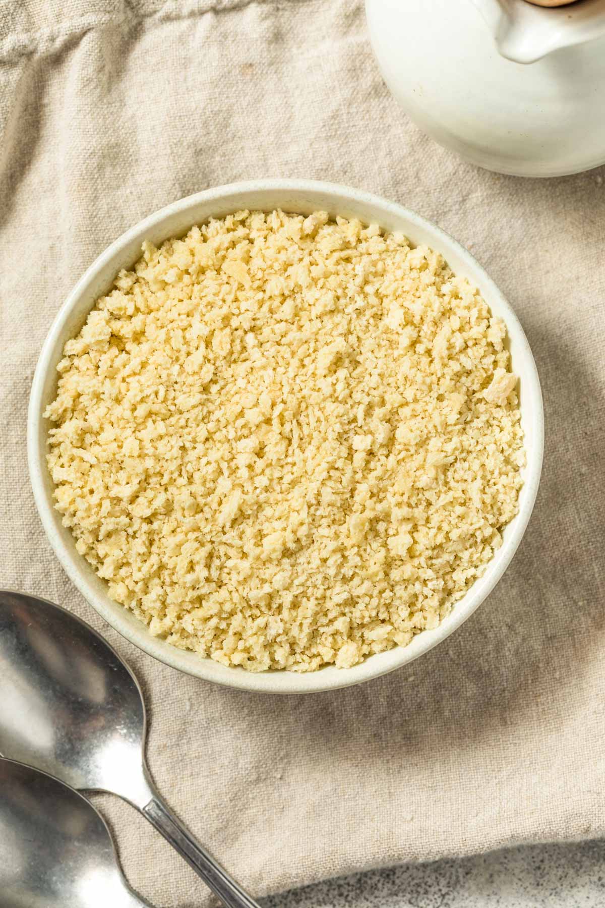 Homemade Panko Breadcrumbs an overhead shot of a small bowl of homemade panko breadcrumbs on a tan linen napkin