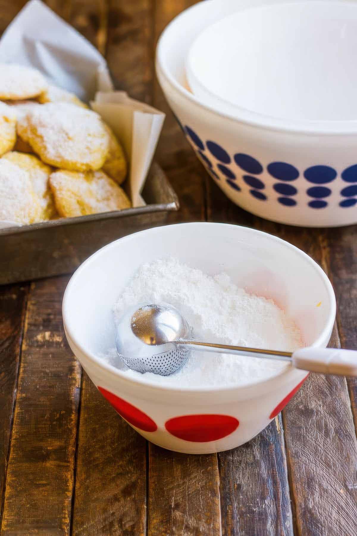 a small vintage mixing bowl filled with powdered sugar