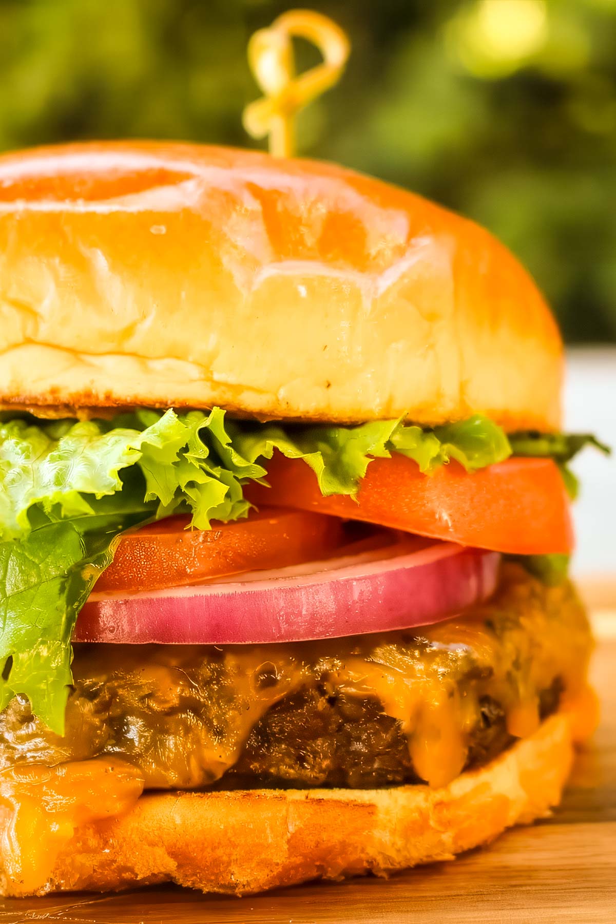 Smoked Hamburgers a smoked hamburger topped with cheese, lettuce, onion, and tomato