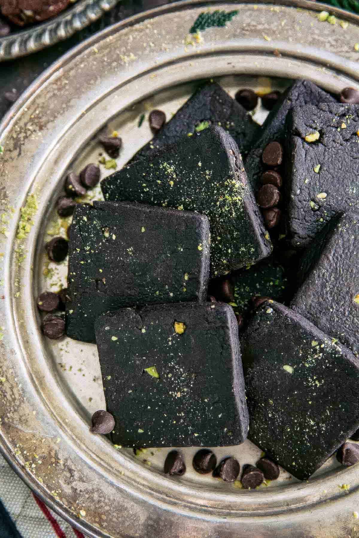 a closeup of a round, vintage silver plate filled with chocolate shortbread cookies