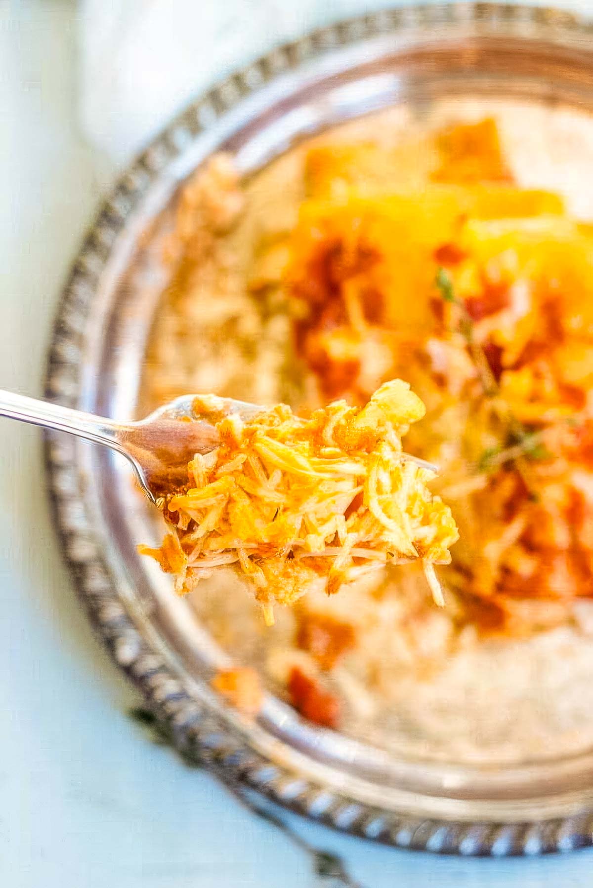 Baked Lemon Ricotta Pasta with Italian Sausage a serving of baked lemon ricotta pasta on a vintage plate with a forkful being scooped out