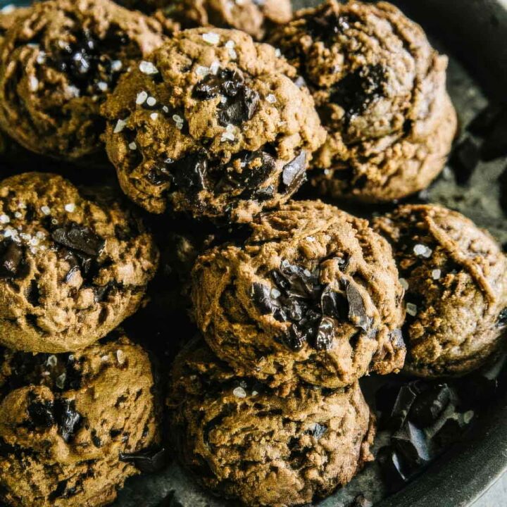 a vintage plate filled with double chocolate cookies topped with sea salt