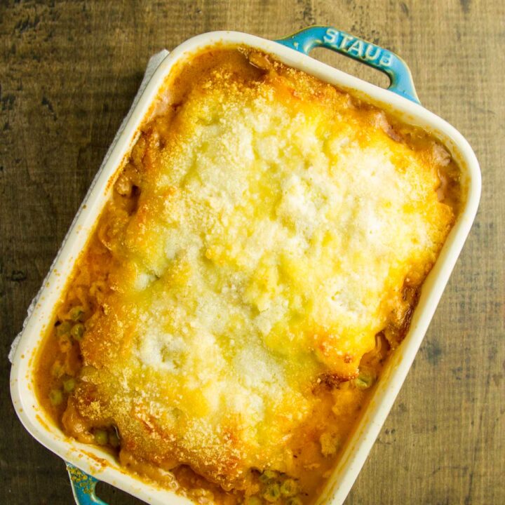 frozen shepherd's pie in a small casserole dish just out of the oven, sitting on a rustic wood table