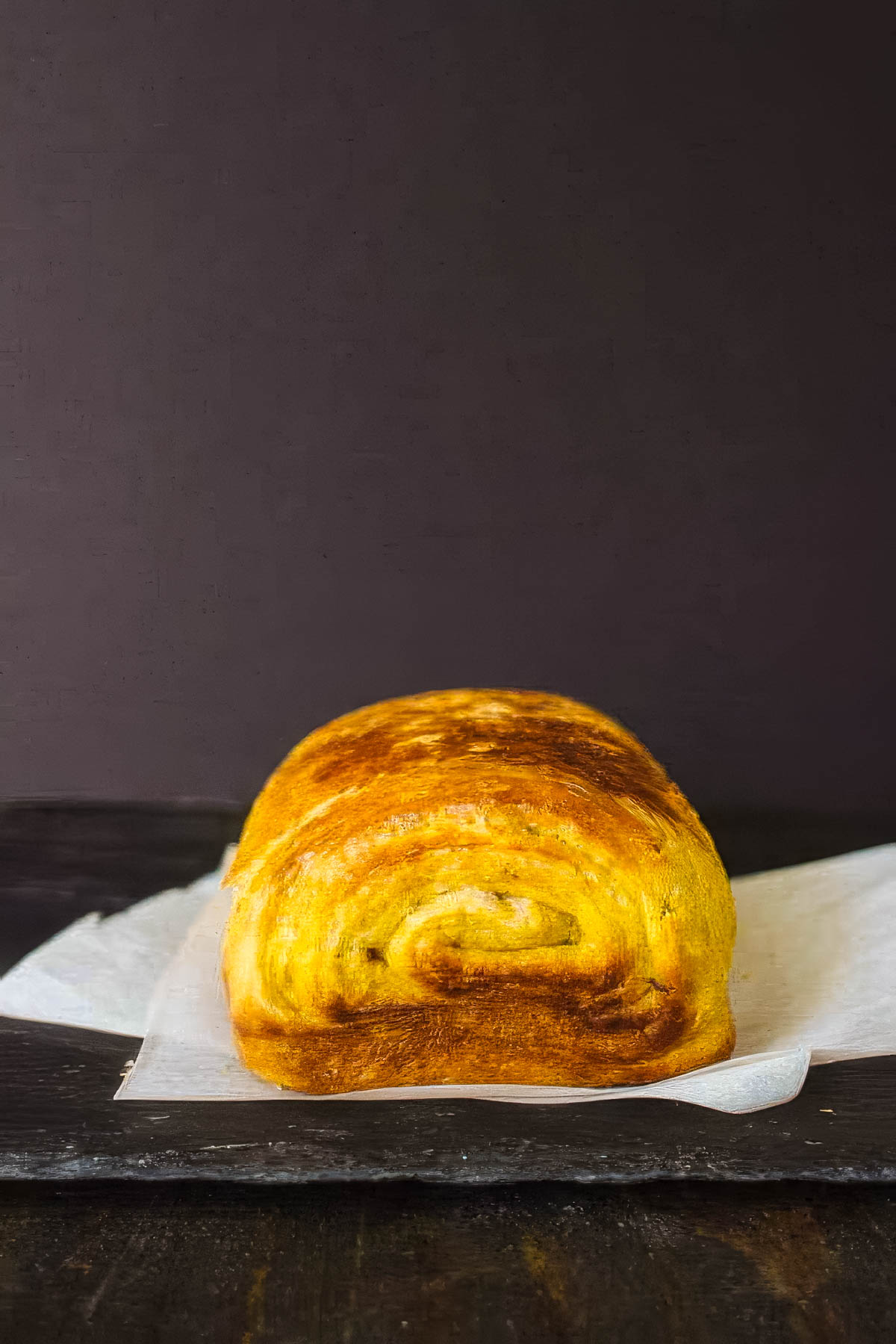 Pumpkin Brioche with Chocolate Swirl a loaf of pumpkin brioche bread on a white cloth napkin