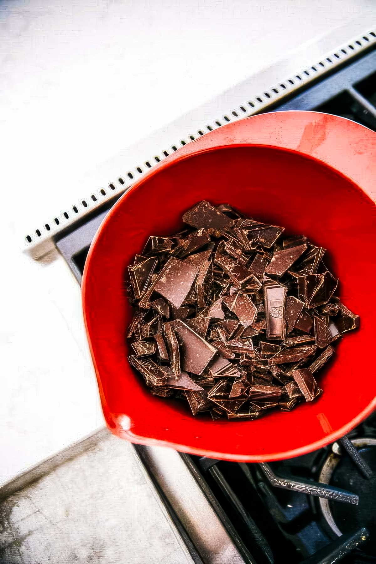 No-Bake Rocky Road Bars with Cashews step 3 for making rocky road bars: chopped chocolate bars being added to the bowl