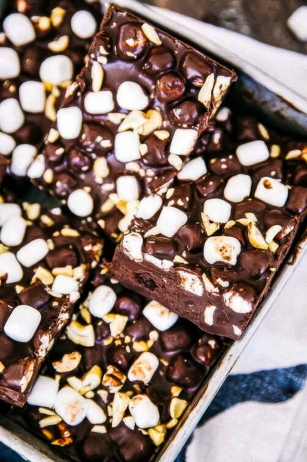 No-Bake Rocky Road Bars with Cashews a closeup of a baking pan filled with slices of rocky road bars