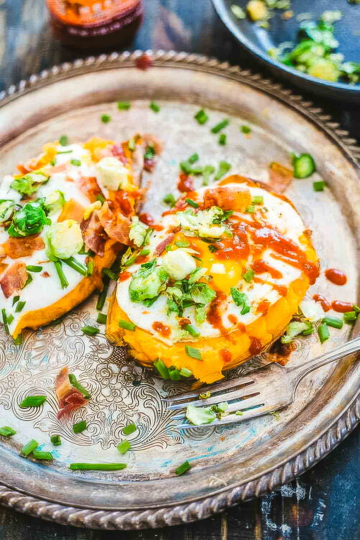Loaded Twice-Baked Sweet Potatoes a vintage platter of twice baked sweet potatoes with a fork